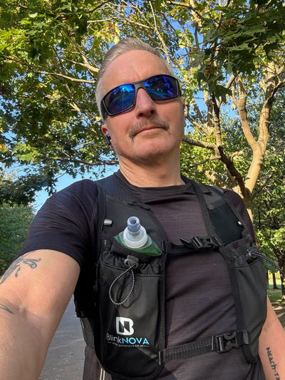 Running man with hydration vest on road run