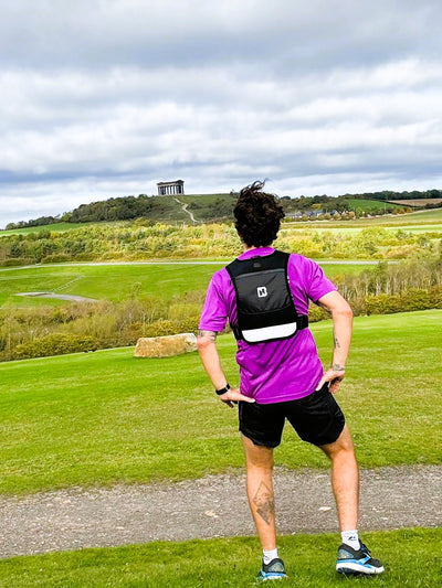 running vest in black with hydration pocket